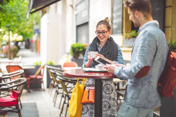 istock Friends are having a hot drink in a sidewalk cafe 1021101348