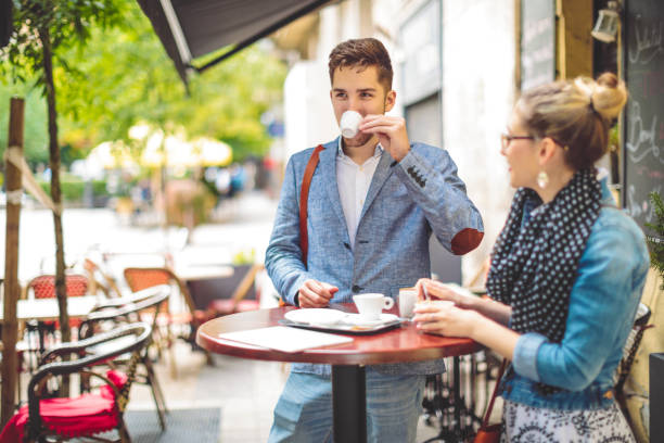 Friends are having a hot drink in a sidewalk cafe
