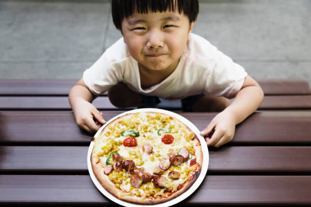 istock Boy showing a smile face pizza 1021101844