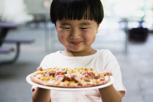 istock Boy showing a smile face pizza 1021101848
