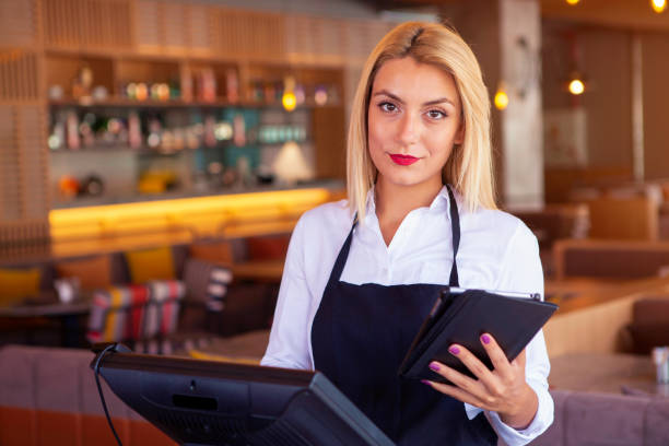 istock Waitress placing an order on the computer at a restaurant 1021105158