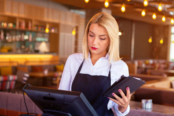 istock Waitress placing an order on the computer at a restaurant 1021105162