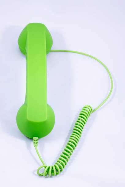 istock Phone with green tube on a white background retro. 1021108870