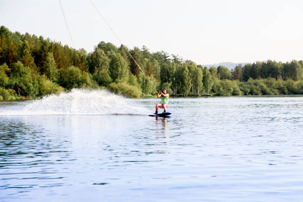 istock Young man riding wakeboard on a lake 1021130248