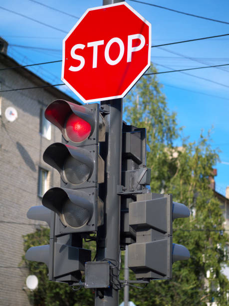 istock red light on traffic light and stop sign above it 1021130318