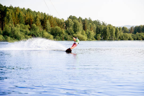istock Young man riding wakeboard on a lake 1021130350
