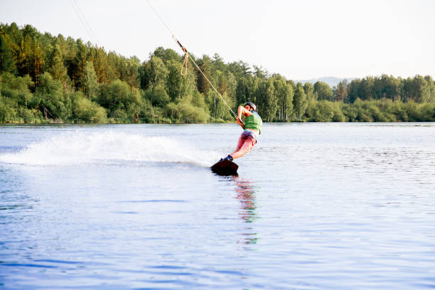 istock Young man riding wakeboard on a lake 1021130370