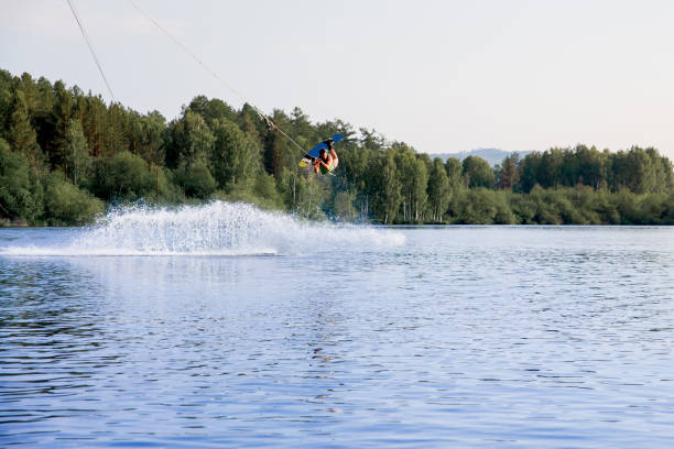 istock Young man riding wakeboard on a lake 1021130698