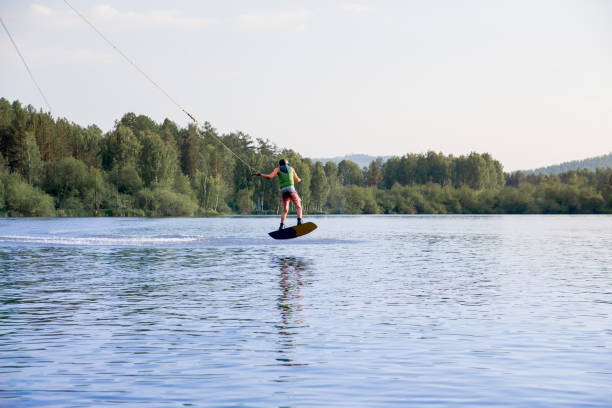 istock Young man riding wakeboard on a lake 1021132766