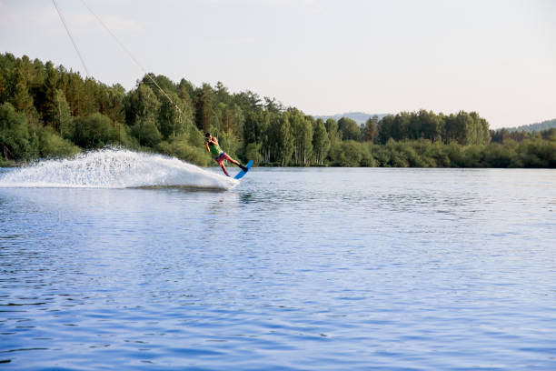 istock Young man riding wakeboard on a lake 1021132812