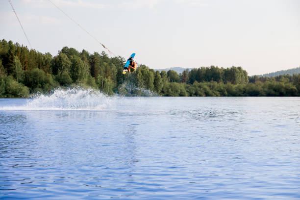 istock Young man riding wakeboard on a lake 1021132874