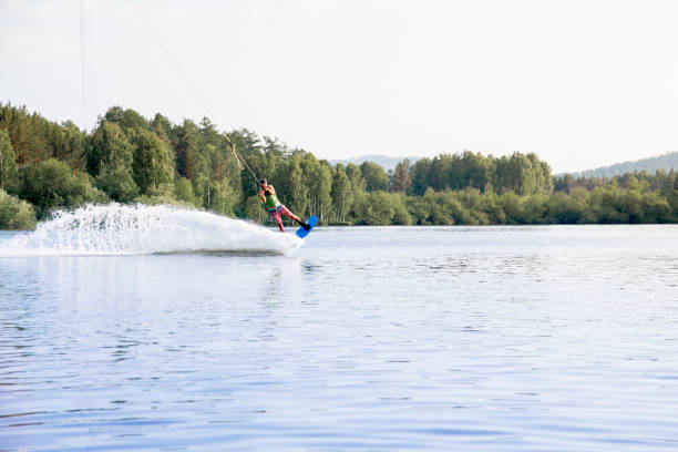 istock Young man riding wakeboard on a lake 1021133020