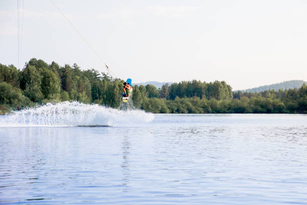 istock Young man riding wakeboard on a lake 1021133038
