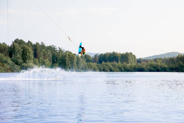 istock Young man riding wakeboard on a lake 1021133050