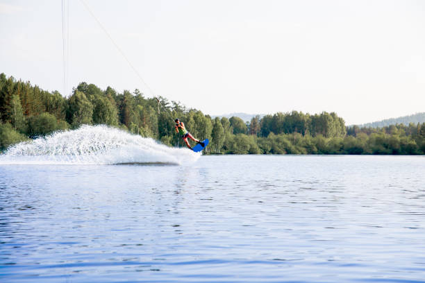 istock Young man riding wakeboard on a lake 1021133194
