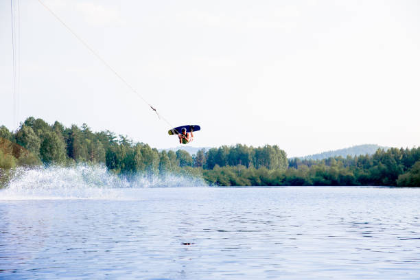 istock Young man riding wakeboard on a lake 1021133228