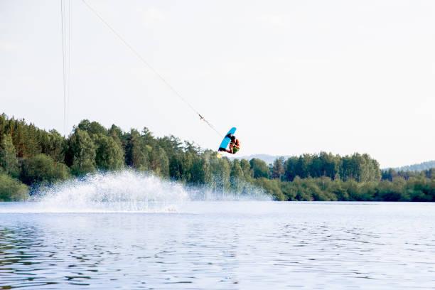 istock Young man riding wakeboard on a lake 1021133294