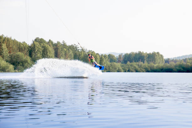 istock Young man riding wakeboard on a lake 1021133342