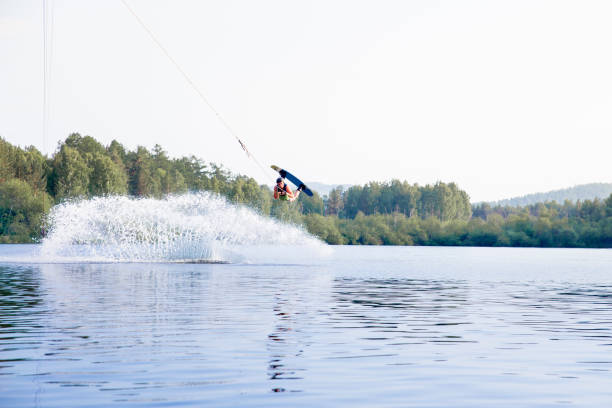 istock Young man riding wakeboard on a lake 1021133376