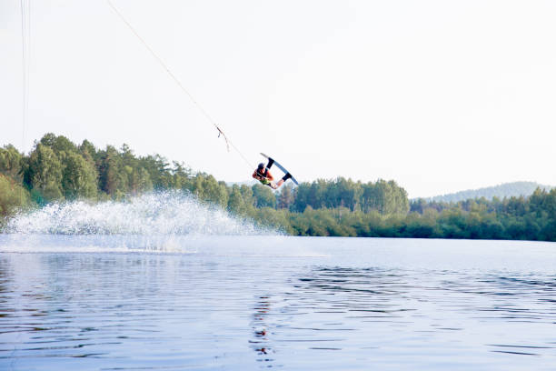 istock Young man riding wakeboard on a lake 1021133394