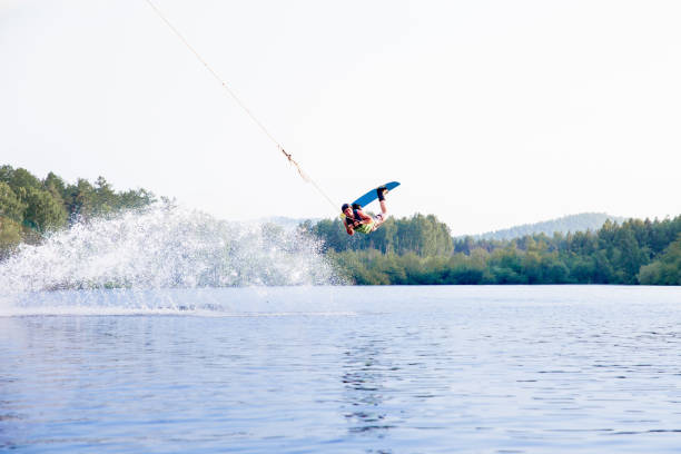 istock Young man riding wakeboard on a lake 1021133412