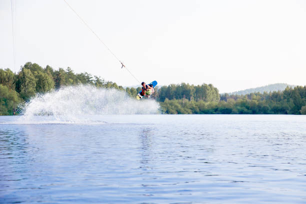 istock Young man riding wakeboard on a lake 1021133464
