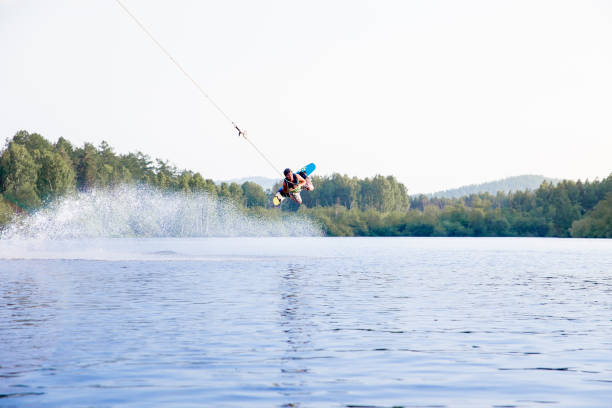 istock Young man riding wakeboard on a lake 1021133496