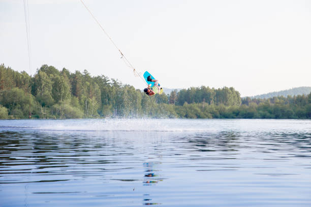 istock Young man riding wakeboard on a lake 1021133620