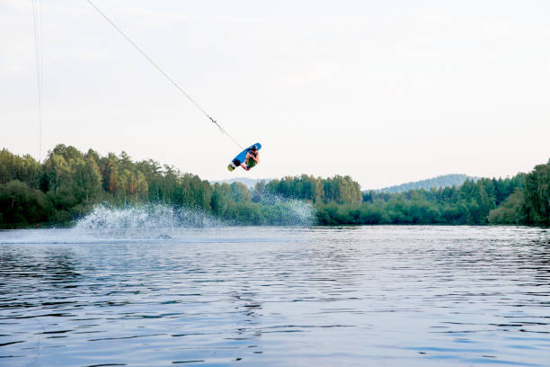 istock Young man riding wakeboard on a lake 1021135432