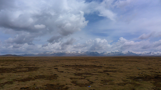 Snow Mountain in the Distance and a Large Area of Grassland
