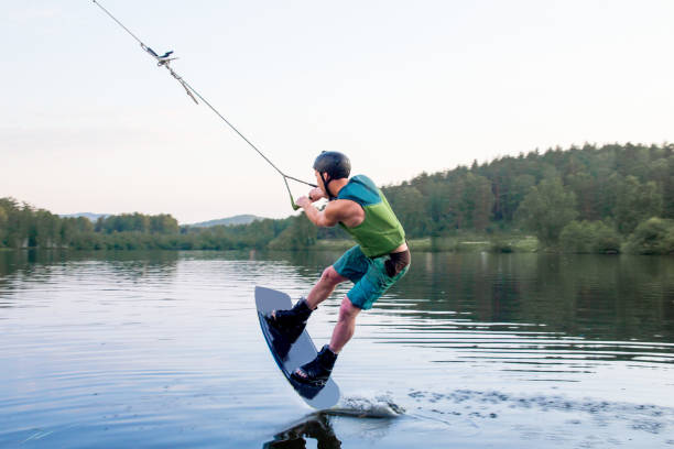 istock Young man riding wakeboard on a lake 1021136282