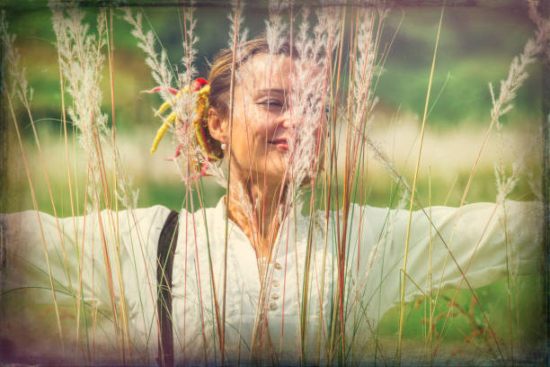 30-35 year old woman in feather grass near the river