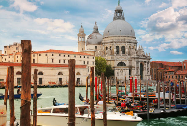 Moored gondolas with Basilica di Santa Maria della Salute in the background in Venice, Italy stock photo