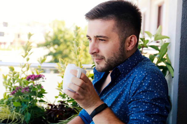 istock Portrait of man holding coffee cup 1021144850