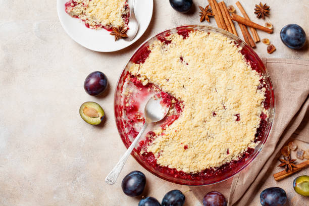 istock Plum crumble with aromatic spice on kitchen table top view. Autumn pastry pie. 1021150016