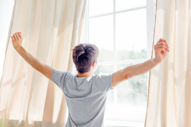 istock A young man waking up in bed in the morning 1021162166