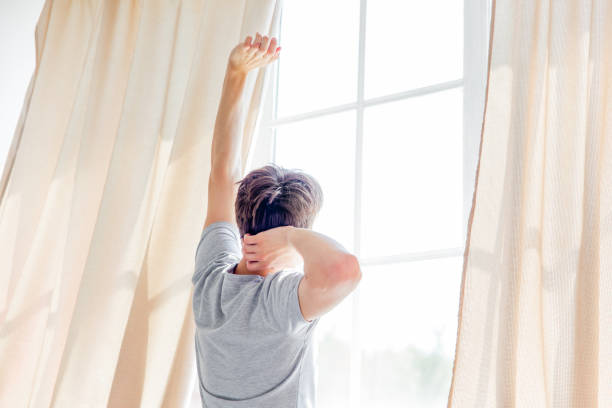 istock A young man waking up in bed in the morning 1021162248