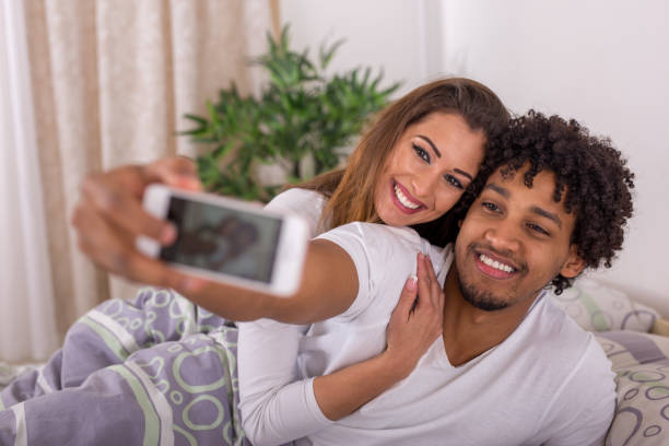 istock Beautiful young couple taking a selfie in bed 1021162618