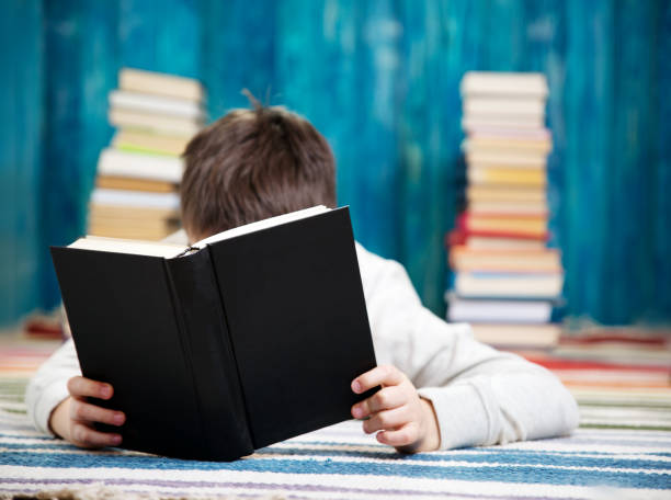 istock eight years old child reading a book 1021169540