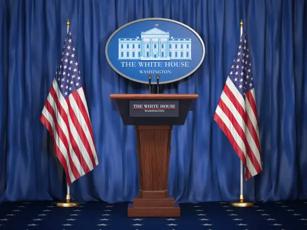 Photo of Briefing of president of US United States in White House. Podium speaker tribune with USA flags and sign of White Houise. Politics concept.