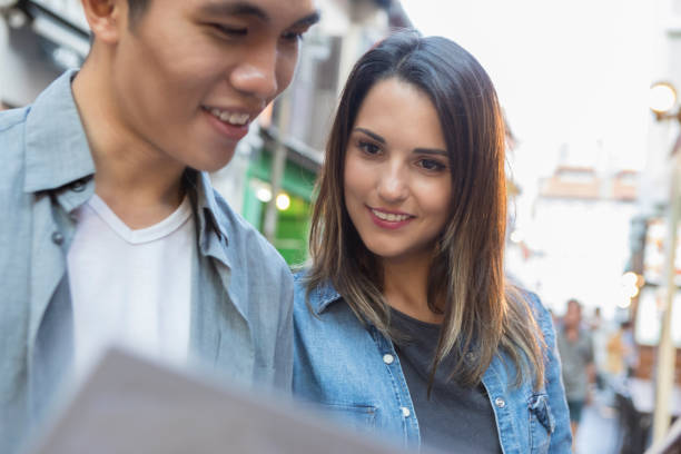 istock Young adults read menu in outdoor cafe 1021177948