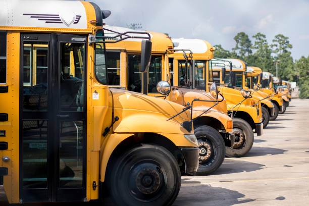 istock Back to School:  School buses in a row at the bus barn. 1021178368