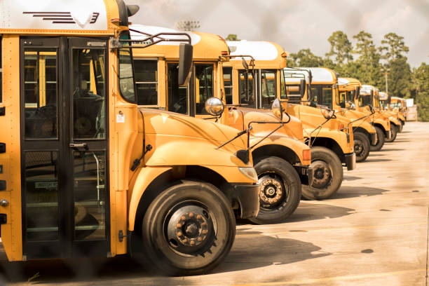 istock Back to School:  School buses in a row at the bus barn. 1021178480