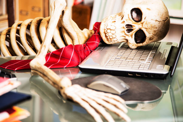 istock Skeleton businessman worked to death in office. 1021181372
