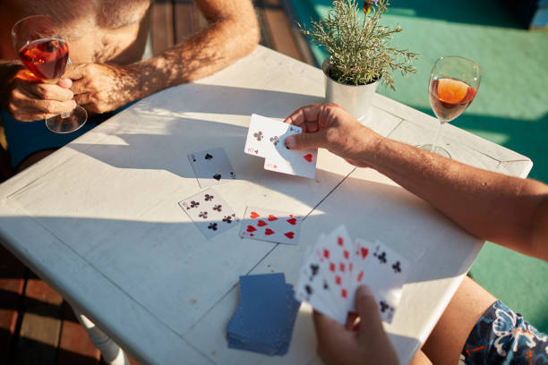 istock Seniors Men Playing Cards On Summer Vacation 1021184172