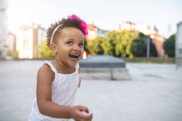 istock Gorgeous mixed race child smiling while running outdoors 1021192288