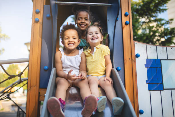 istock Gorgeous multi-ethnic children group sitting on a slide 1021194684