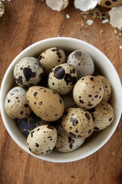 istock Quail eggs in deep white plate on wooden surface 1021202056