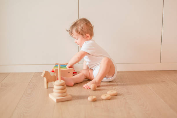 istock Cute little baby boy playing with stacking rings 1021214798