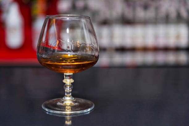 istock A glass of cognac is on the table, a blurry background 1021220582